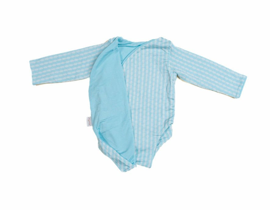 Reversible lil surfer design long-sleeve baby onesie in silky modal fabric.