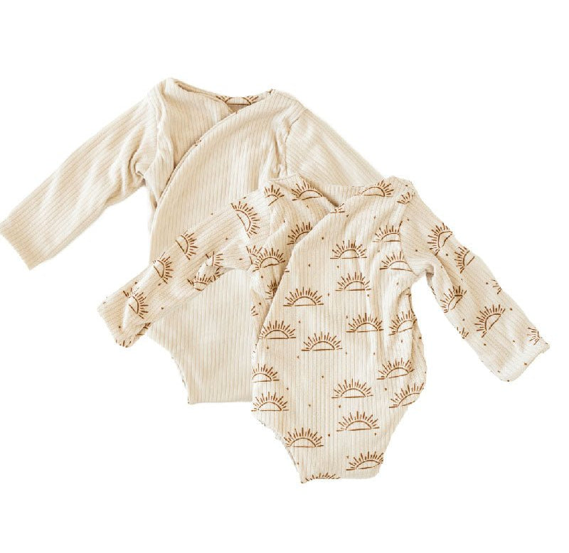 Reversible long-sleeve winged bodysuit in sandy sunsets design.