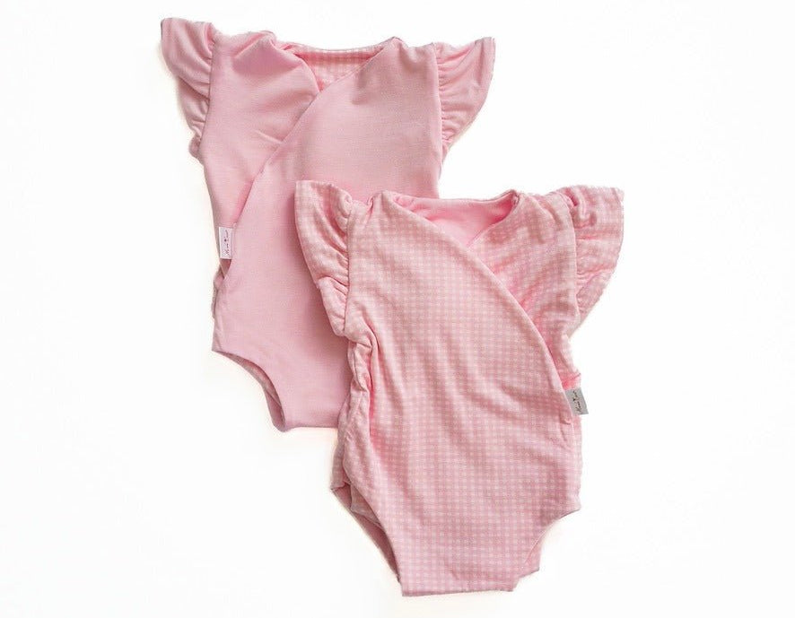 Reversible baby pink gingham design flutter sleeve baby onesie in silky modal fabric.