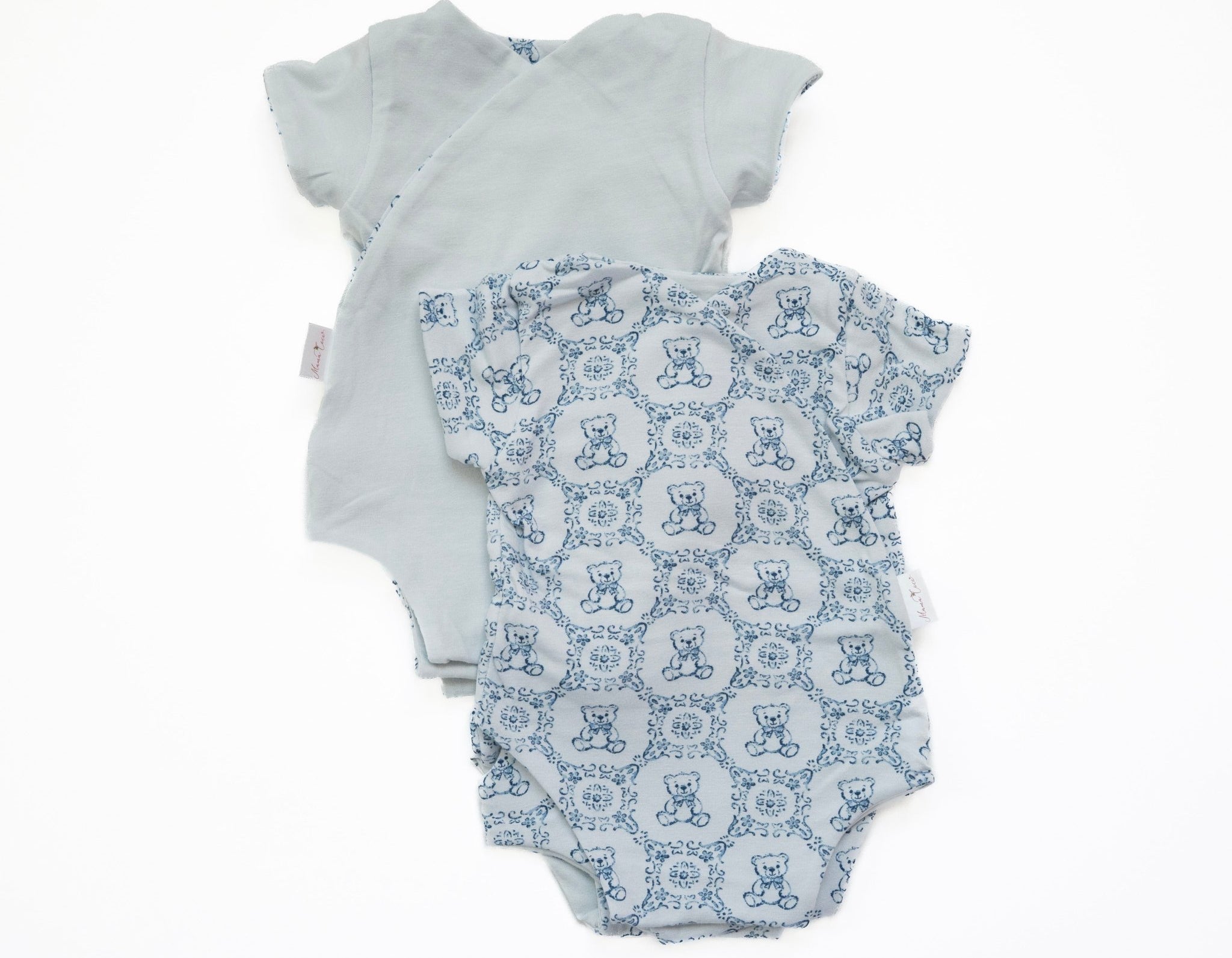 Reversible short-sleeve baby onesie in teddy tiles design.