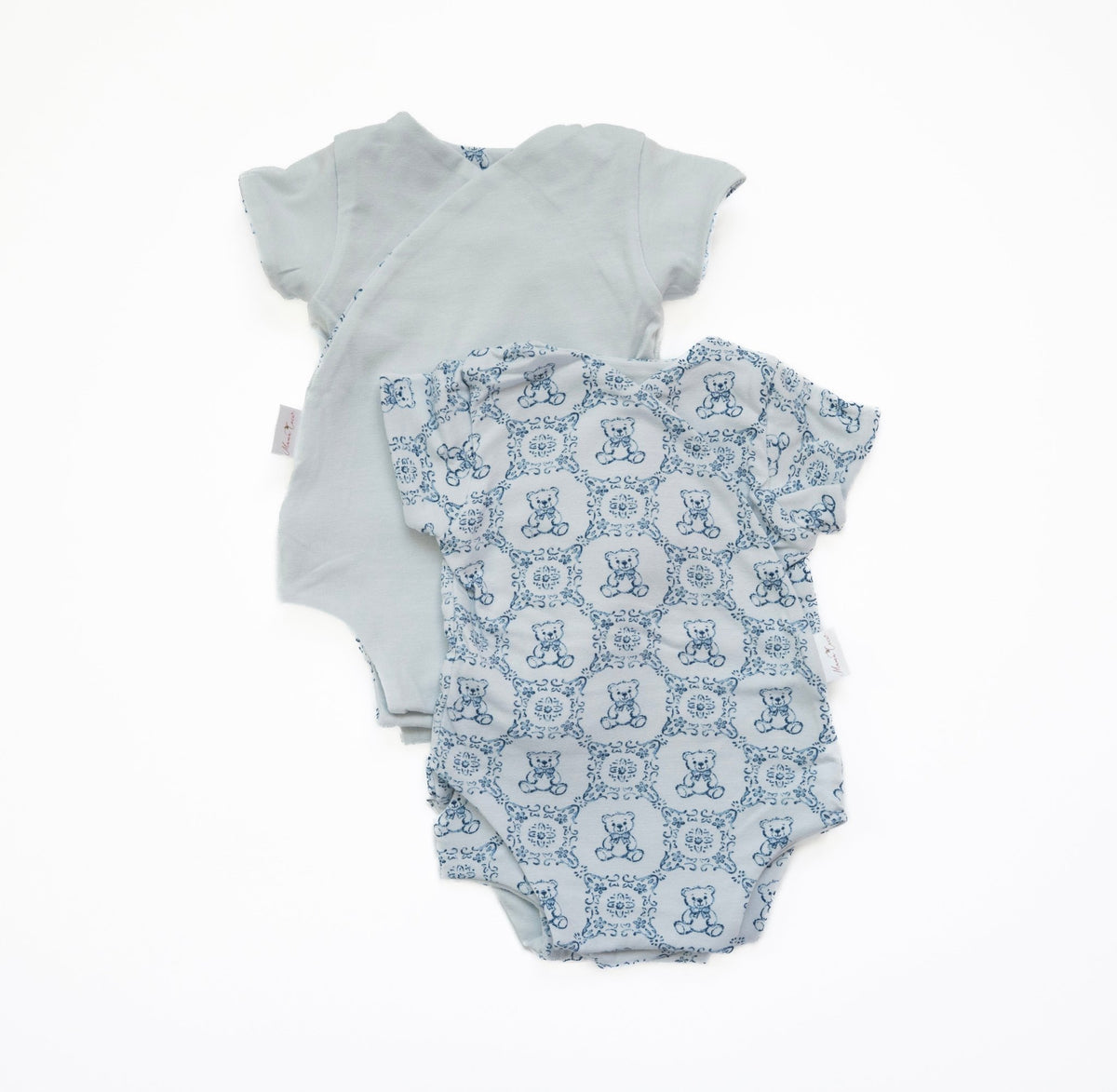 Reversible short-sleeve baby onesie in teddy tiles design.