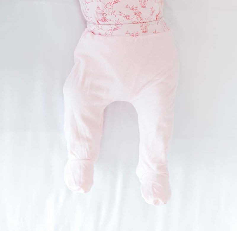 Reversible baby footie pants in whimsical garden design.