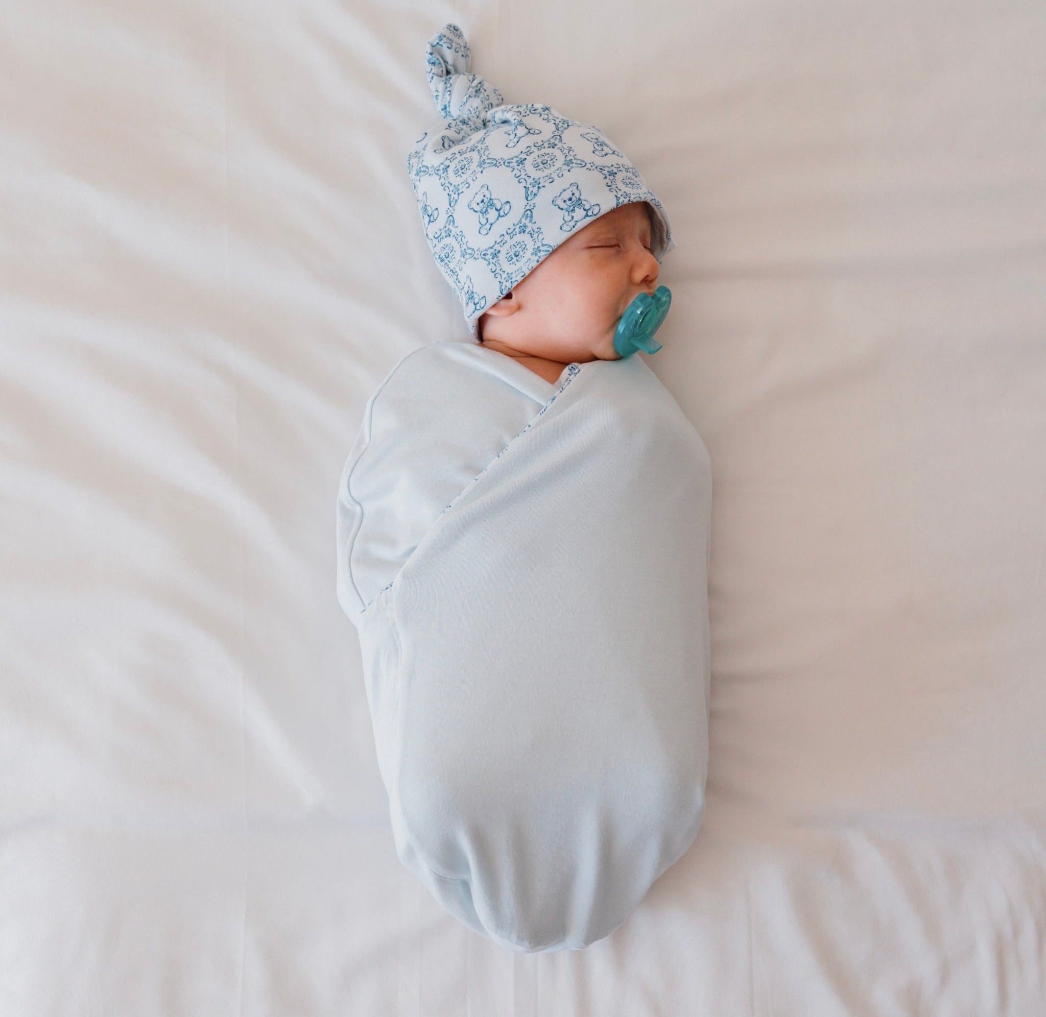 Reversible baby swaddle cocoon blanket crafted from bamboo and organic cotton fabric, decorated with our Teddy Tiles design.