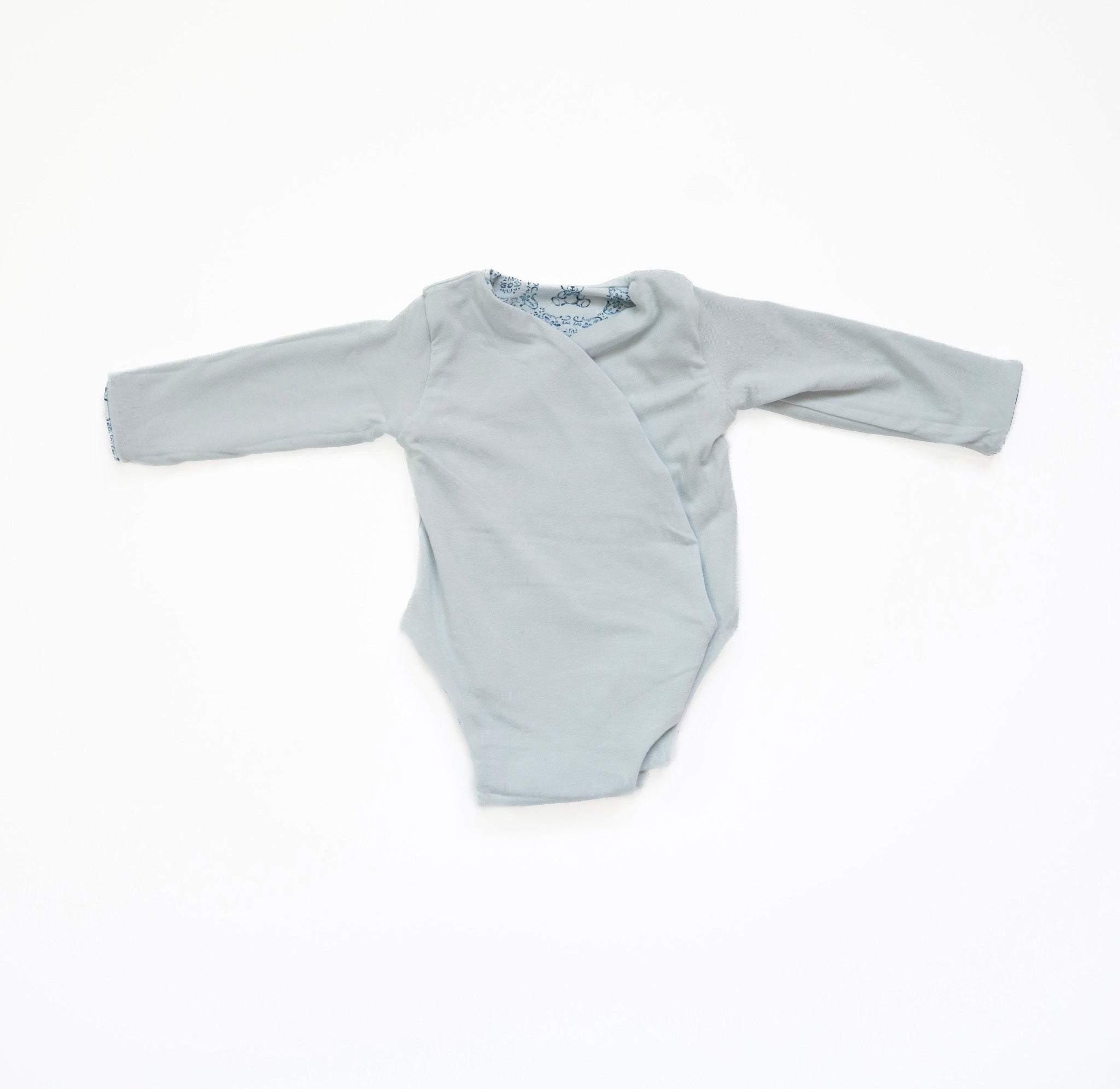 Reversible long-sleeve winged bodysuit for babies.