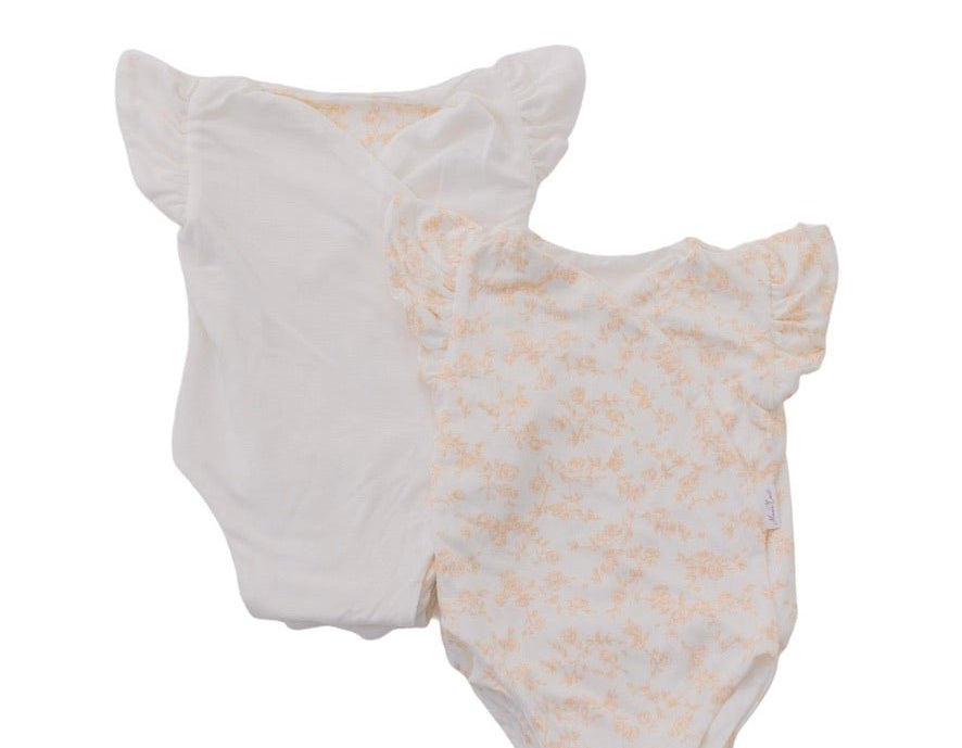 Reversible bitty blooms design flutter sleeve baby onesie in silky modal fabric.