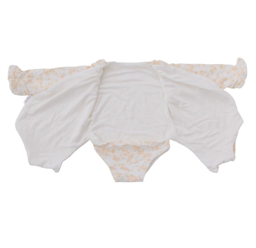 Reversible long sleeved winged bodysuit for babies in silky modal fabric with ruffle cuffs.