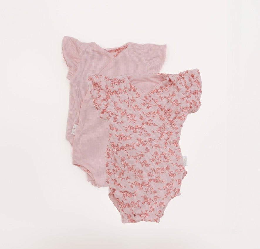 Reversible bitty pink blooms design flutter sleeve baby onesie in silky modal fabric.