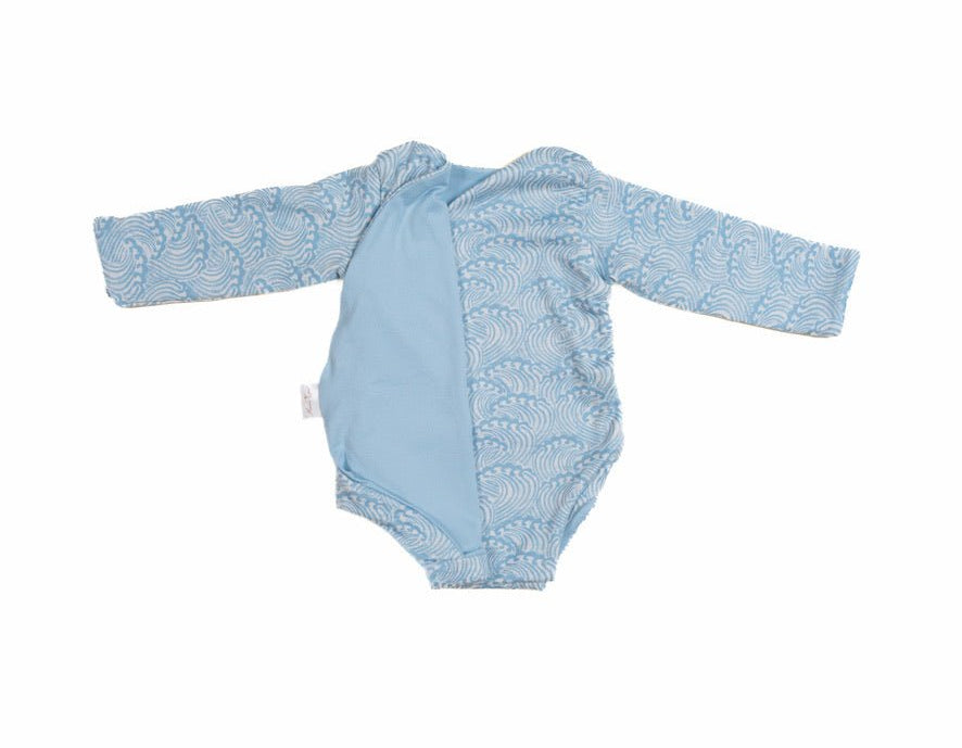 Reversible blue swells design long-sleeve baby onesie in classic brushed fabric.