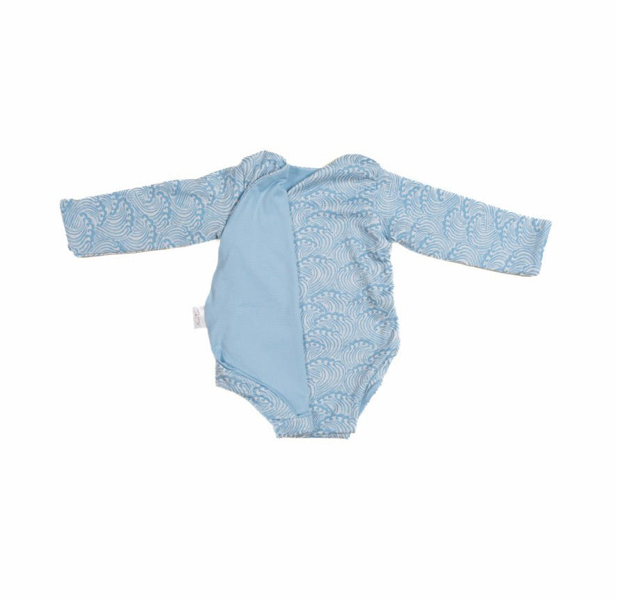 Reversible blue swells design long-sleeve baby onesie in classic brushed fabric.