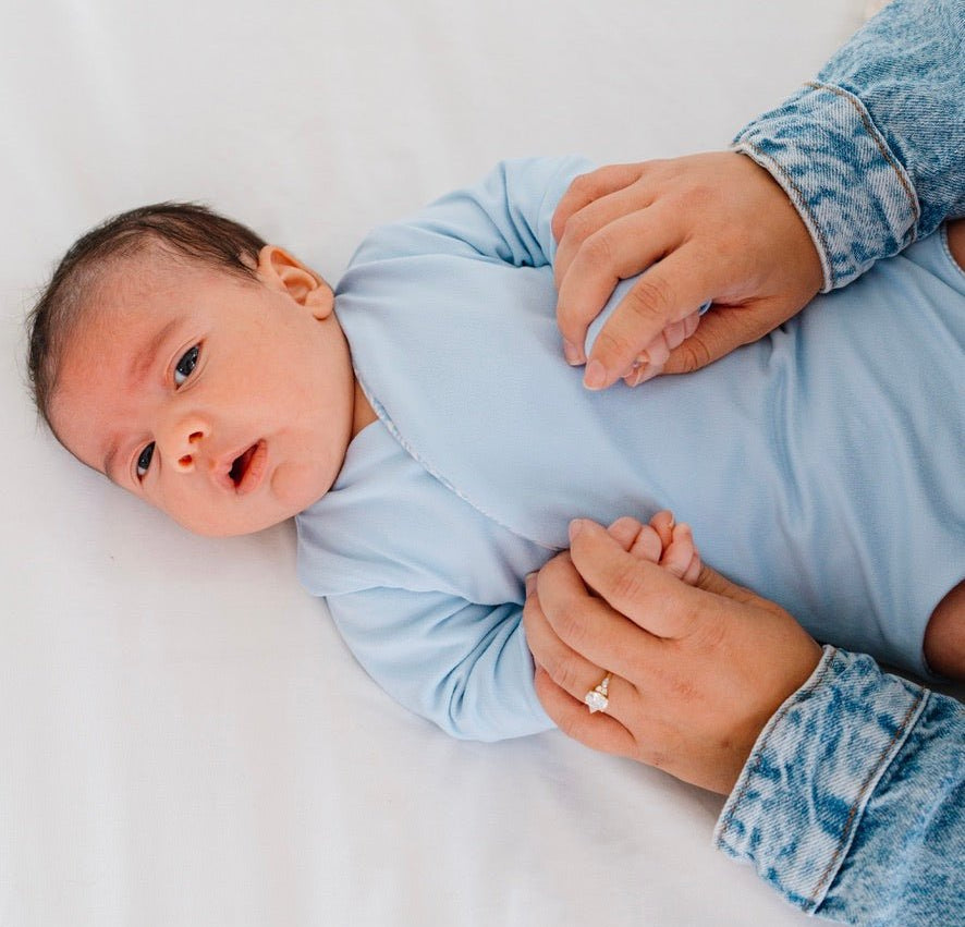 Reversible Blue Swells design long-sleeved winged bodysuit in classic brushed fabric.