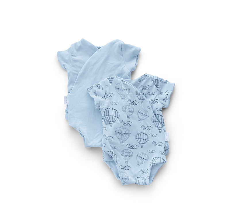 Reversible short-sleeve baby onesie in bon voyage design.