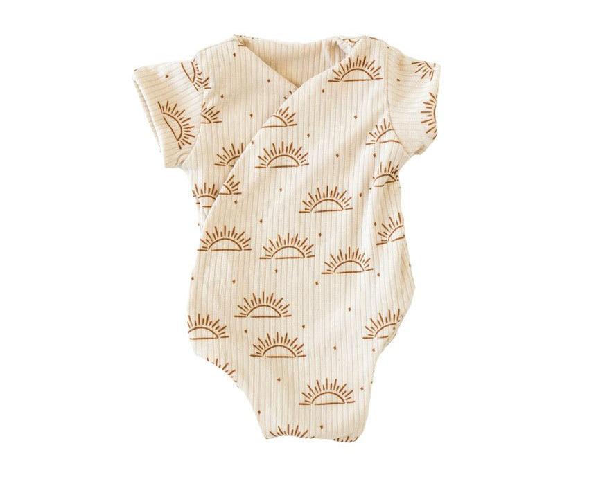 Reversible sandy sunsets design cocoon baby swaddle in classic brushed fabric.