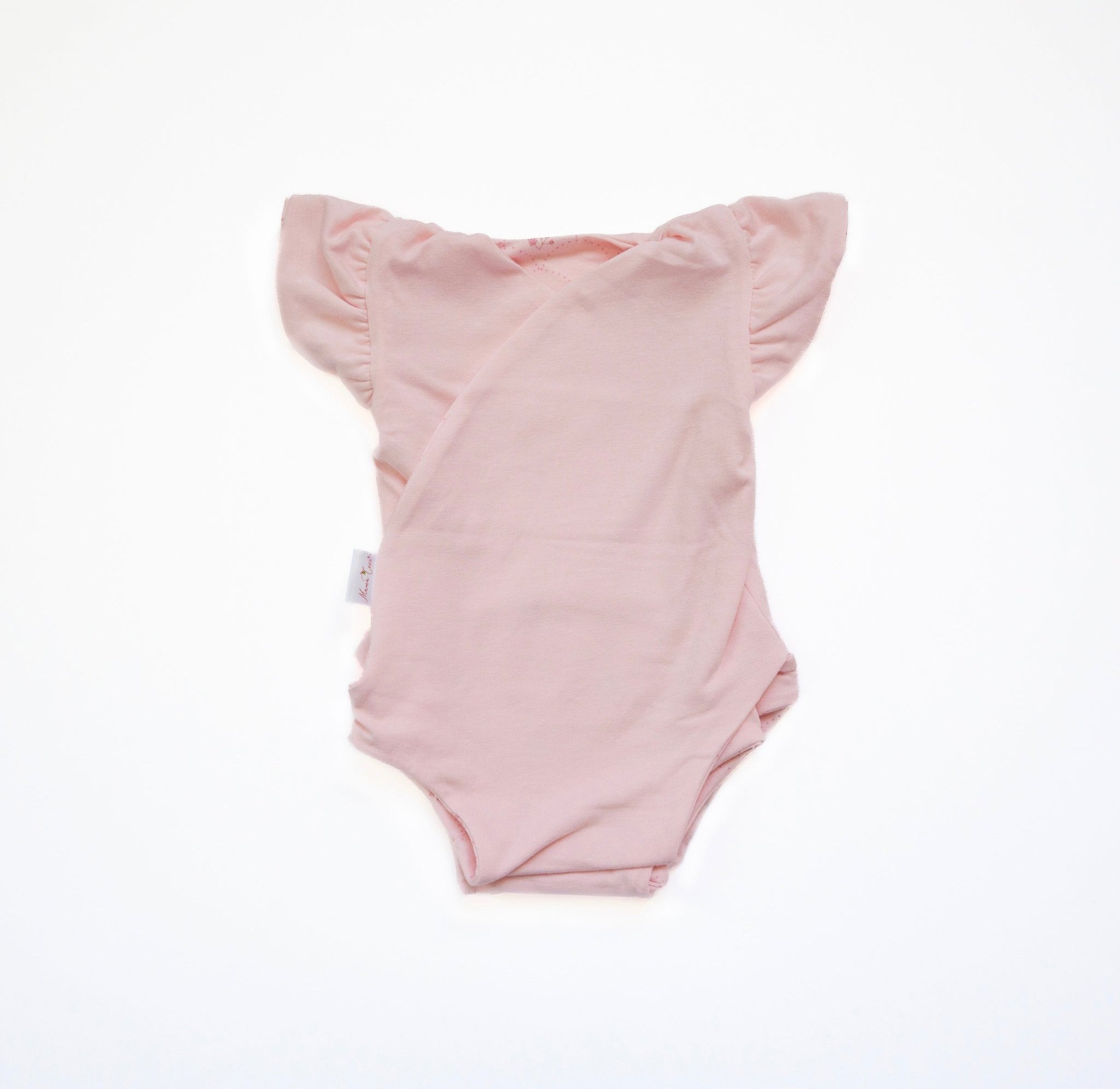 Reversible flutter sleeve winged bodysuit for babies in dainty dots design.