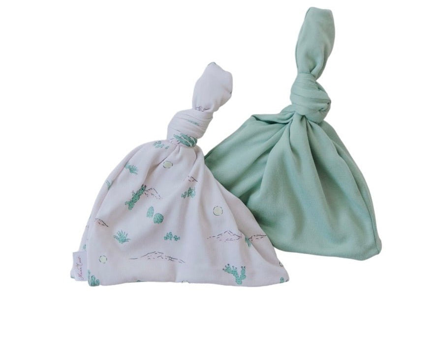 Reversible silky modal baby beanie in desert sunsets design.