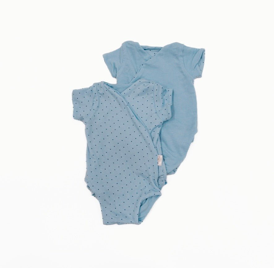 Reversible short-sleeve baby winged bodysuit in a dotted blue design.
