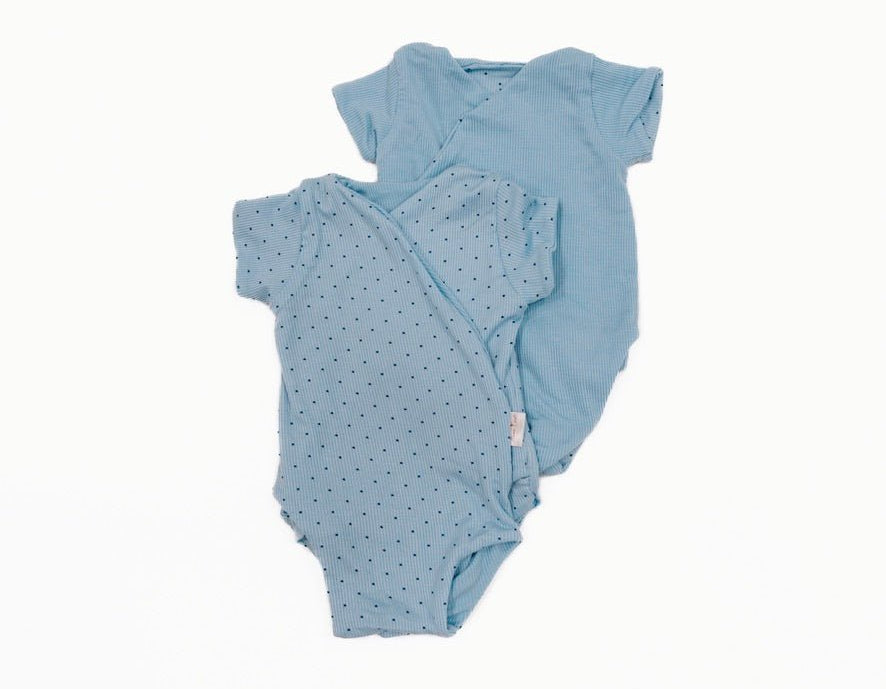 Reversible dotted blues design short-sleeve baby onesie in silky modal fabric.