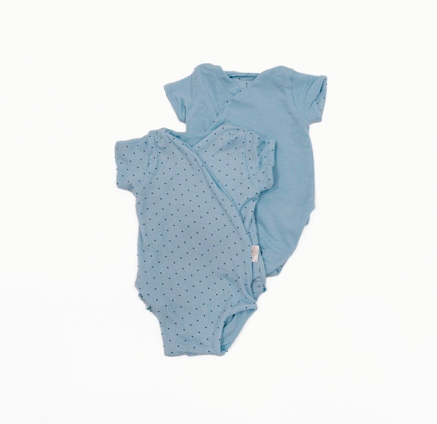 Reversible dotted blues design short-sleeve baby onesie in silky modal fabric.