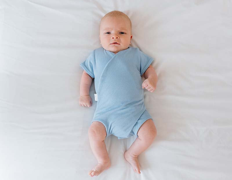 Reversible Dotted Blues design short sleeved winged bodysuit in silky modal fabric.