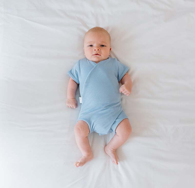 Reversible Dotted Blues design short-sleeved winged bodysuit in silky modal fabric.