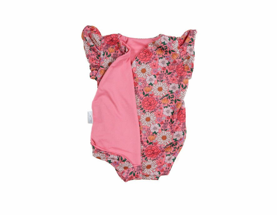 Reversible flower power design flutter sleeve baby onesie in classic brushed fabric.