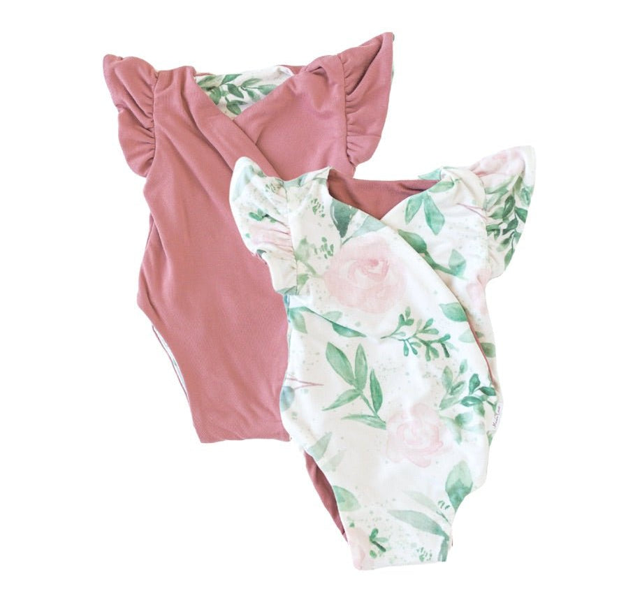 Reversible flutter sleeve baby onesie in blushing eucalyptus design.