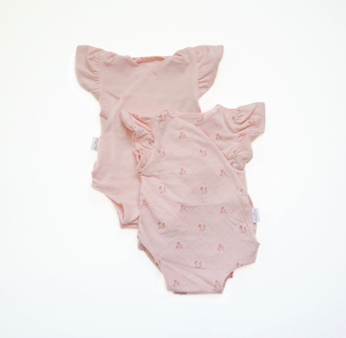 Reversible flutter sleeve baby onesie in dainty dots design.