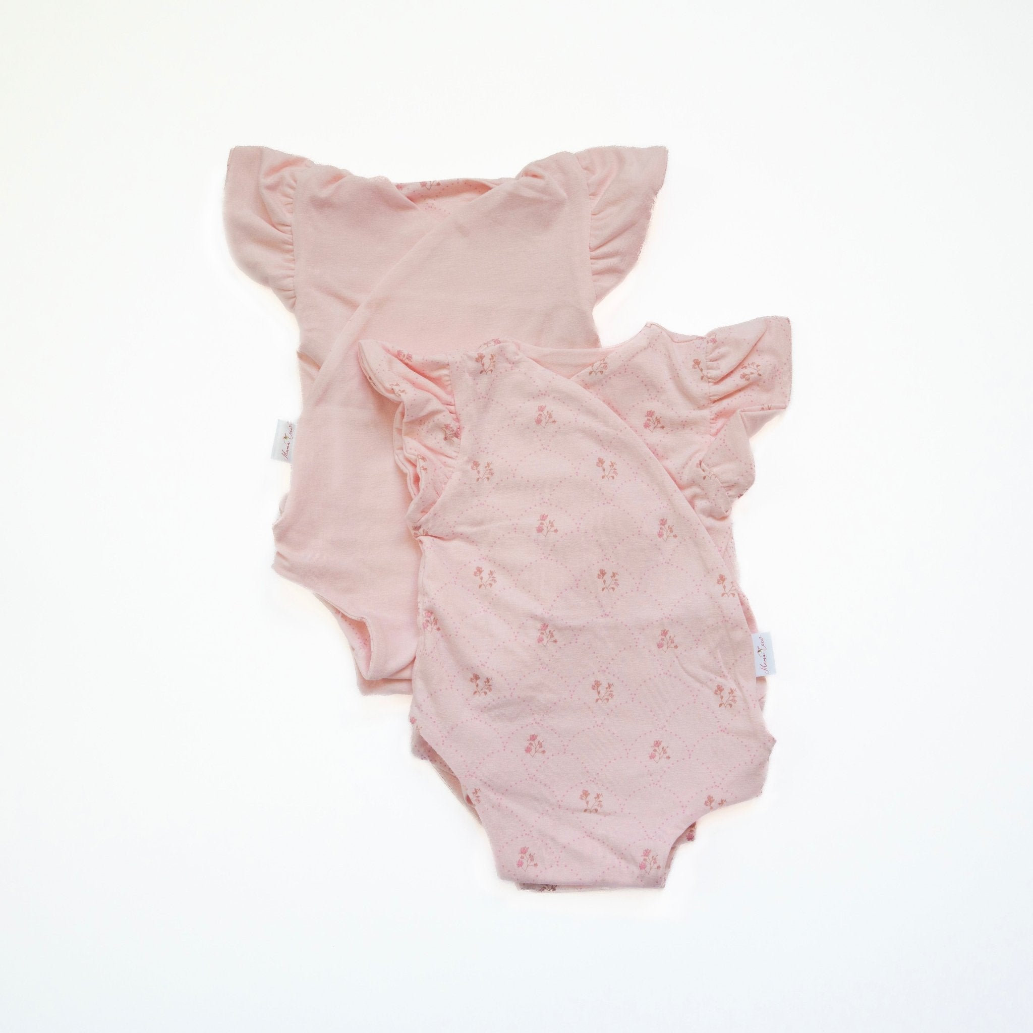 Reversible flutter sleeve baby onesie in dainty dots design.
