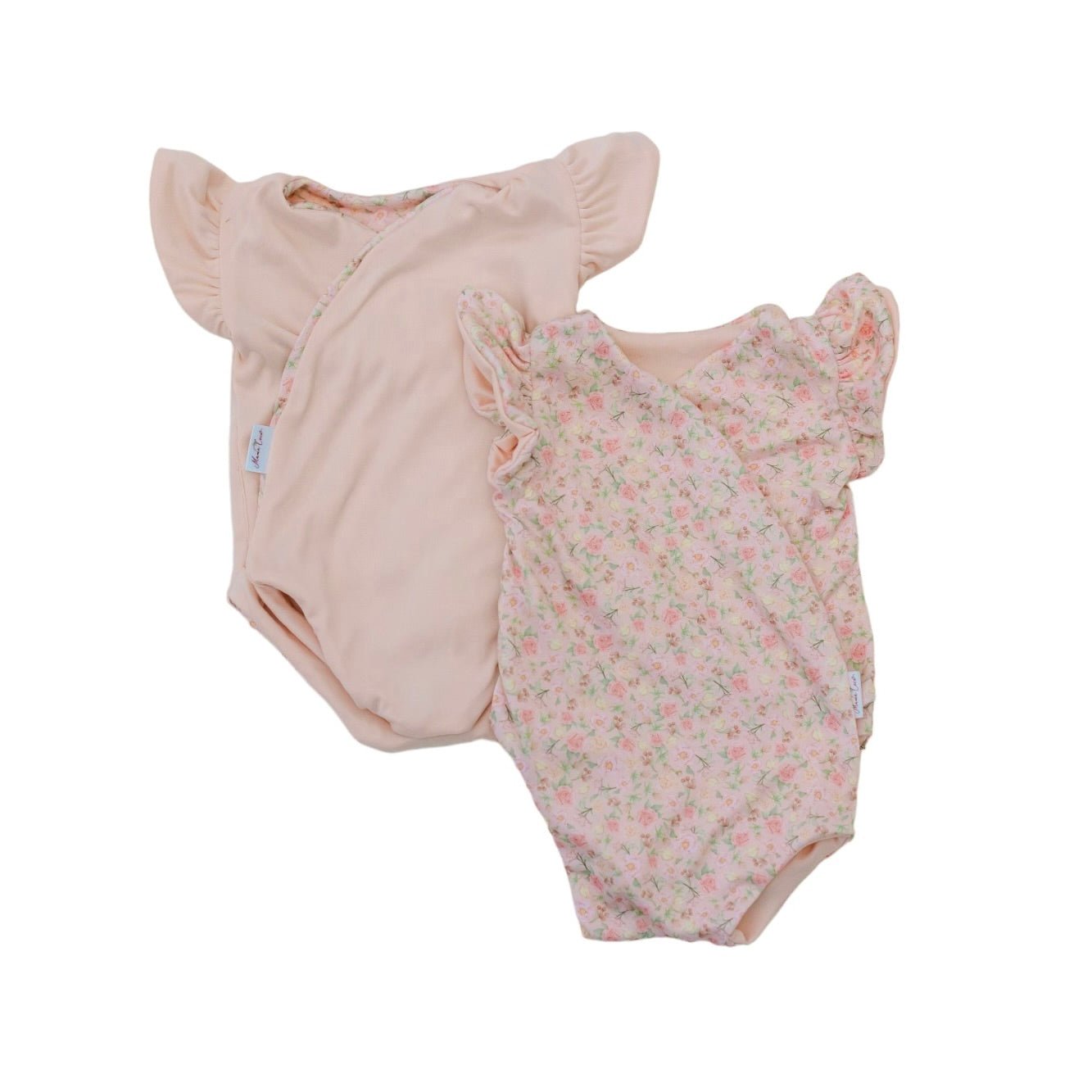 Reversible flutter sleeve baby onesie in dusty roses design.