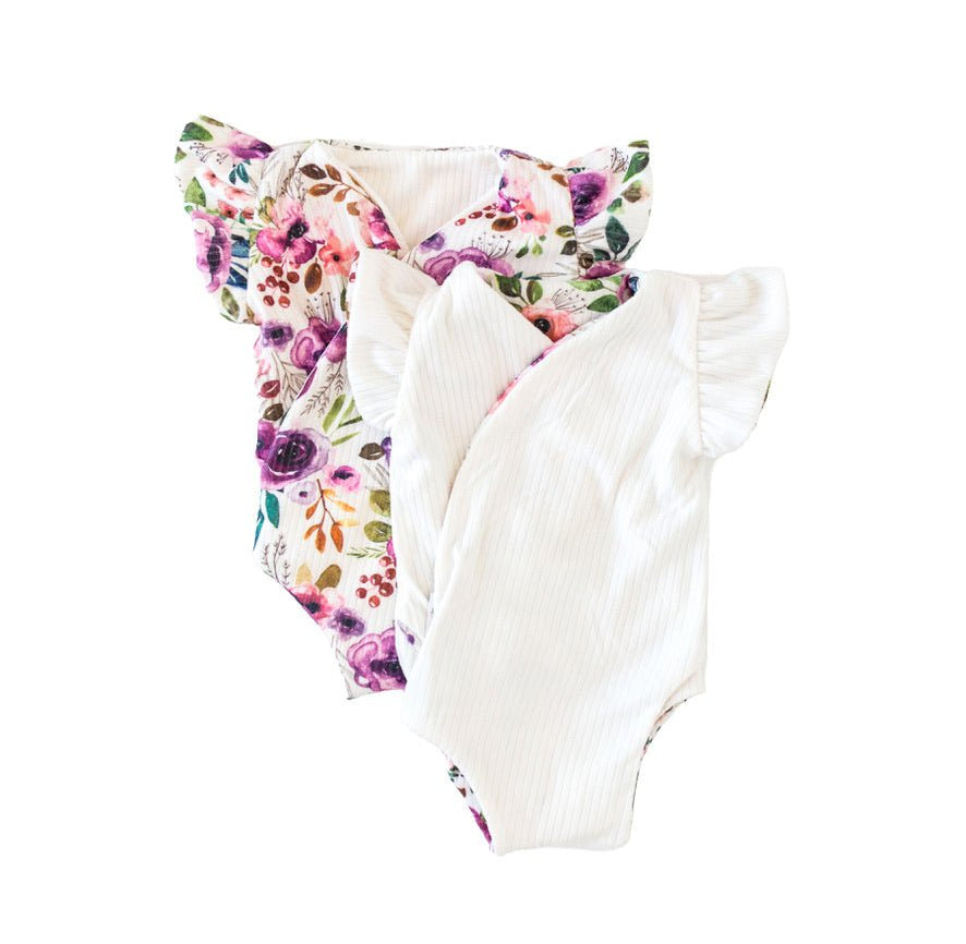 Reversible flutter sleeve baby onesie in ivory wildflowers design.