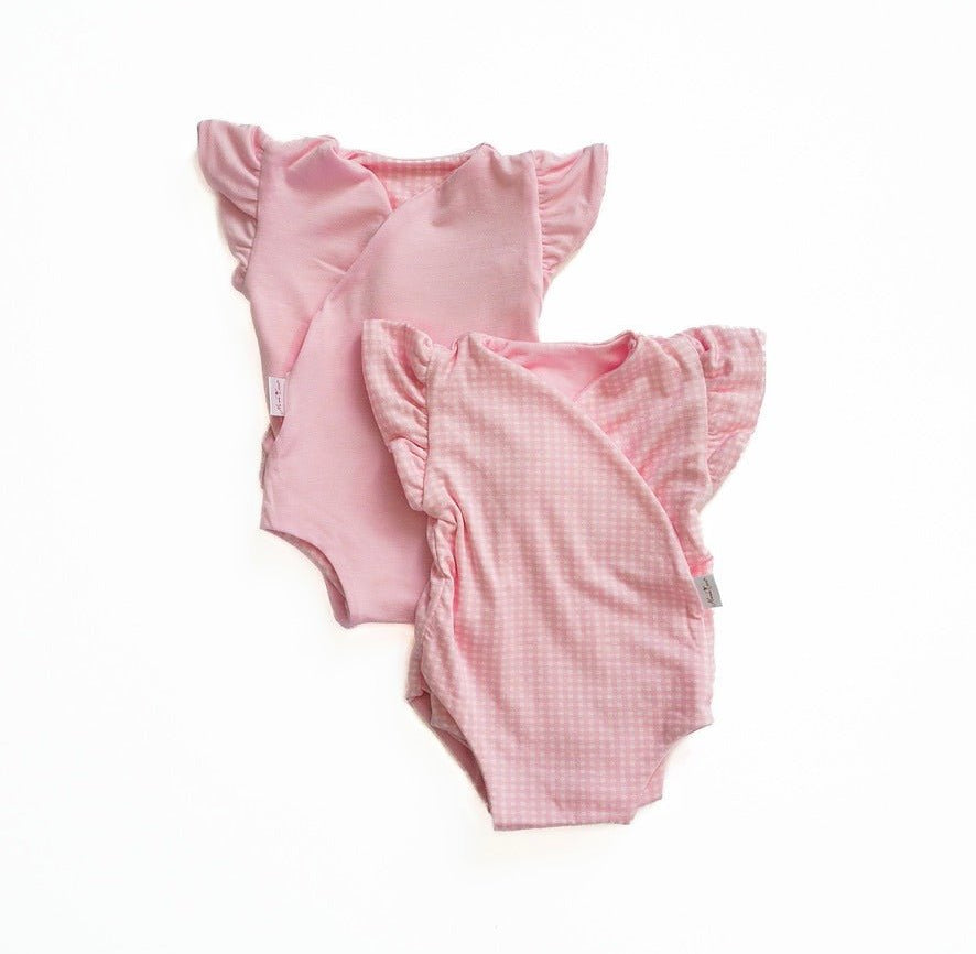 Reversible flutter sleeve baby onesie in Baby Pink Gingham design.