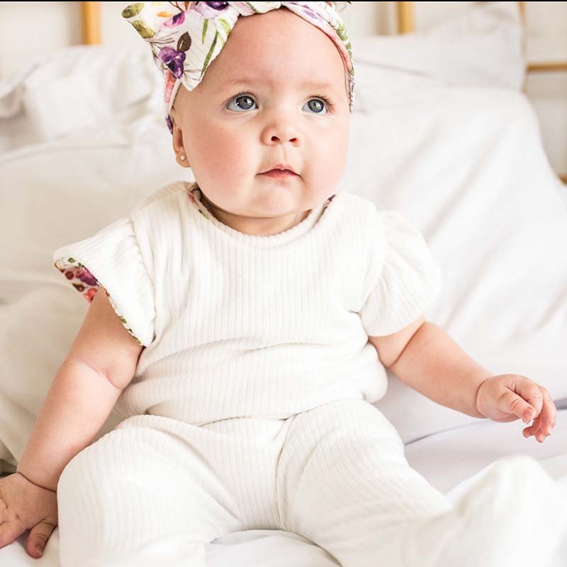 Reversible baby footie pants designed in bamboo cotton fabric featuring our Ivory Wildflowers design.