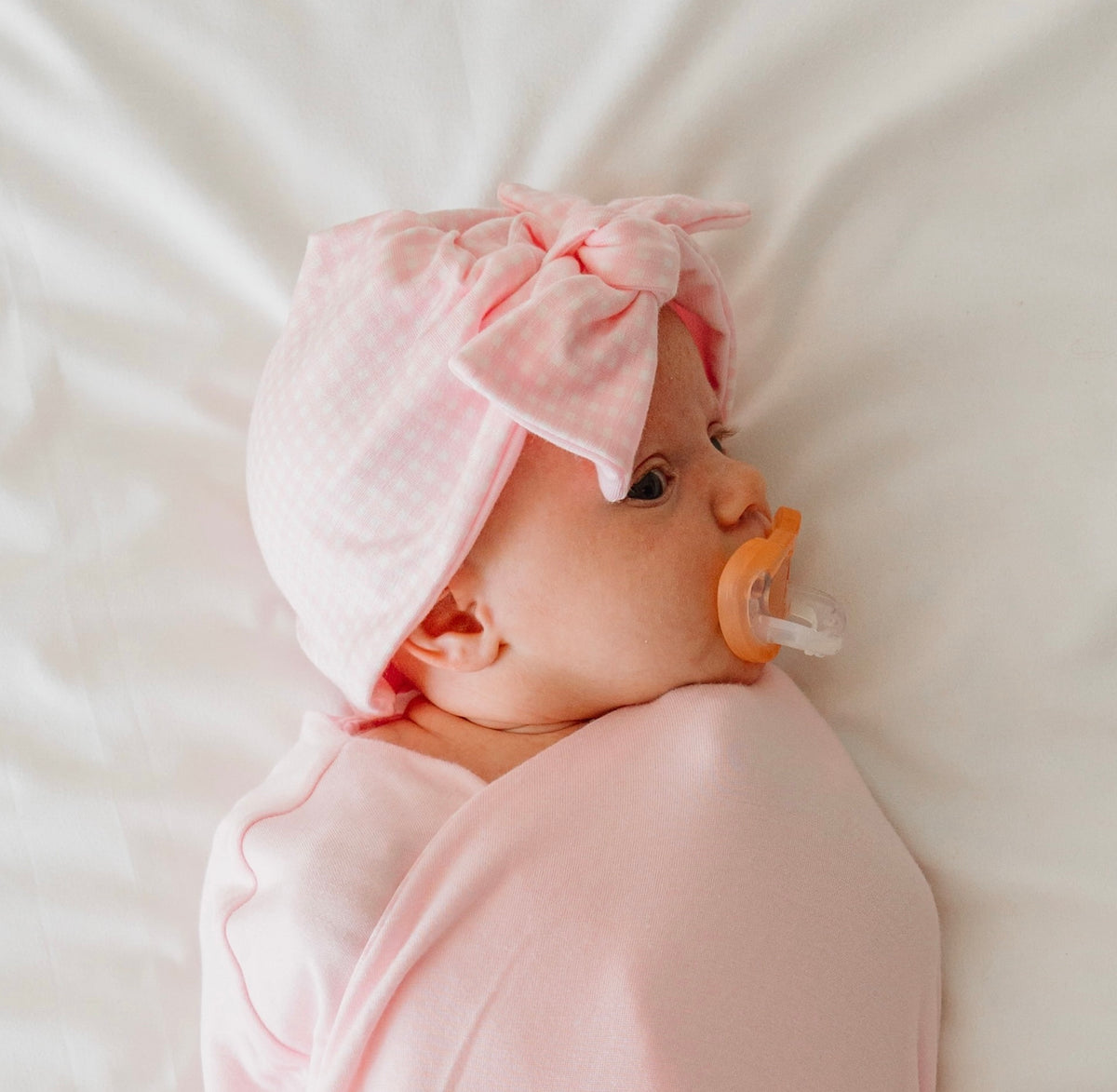 Reversible baby pink gingham design knotty beanie.