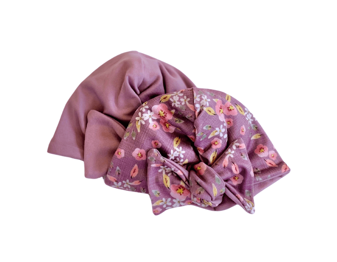 Peachy lilac design reversible baby knotty beanie in classic brushed fabric.