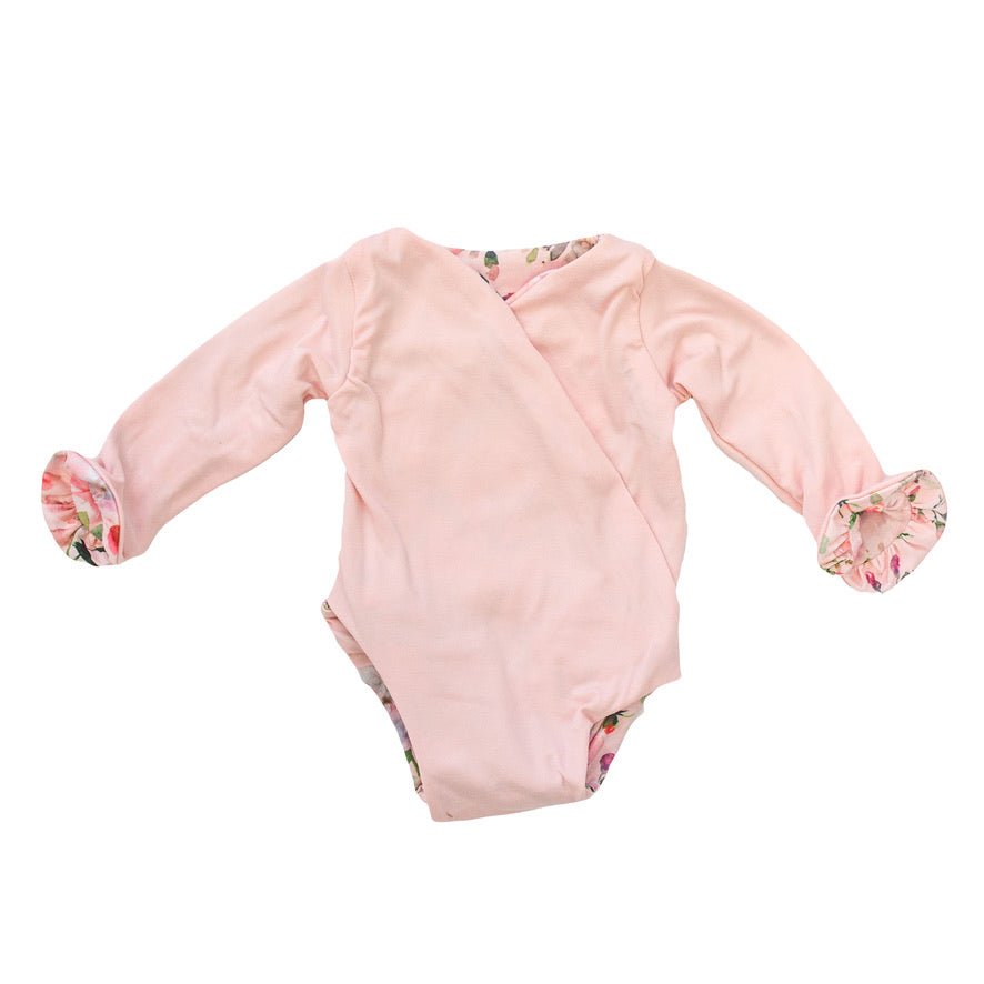 Reversible winged long sleeve infant bodysuit crafted from cozy Peachy Rose Fields design brushed fabric with ruffle cuffs.