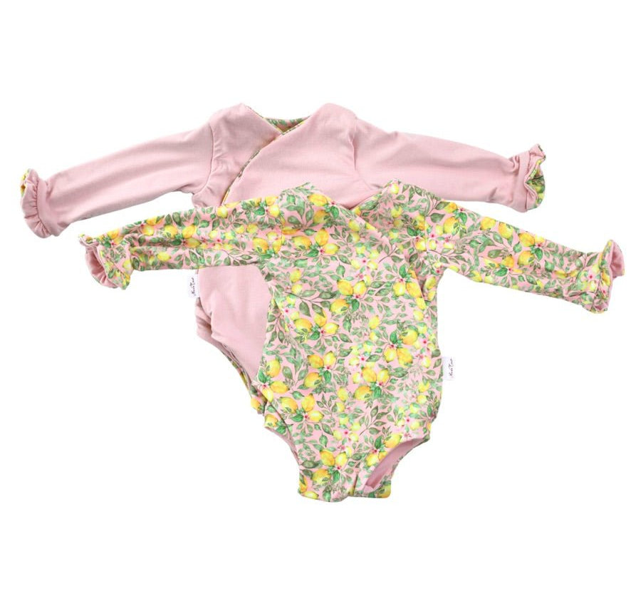 Reversible ruffle cuff baby bodysuit with wings in Pink Lemonade design classic brushed fabric for babies.