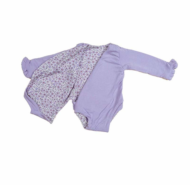 Reversible long sleeved winged bodysuit for babies in silky modal fabric with ruffle cuffs.