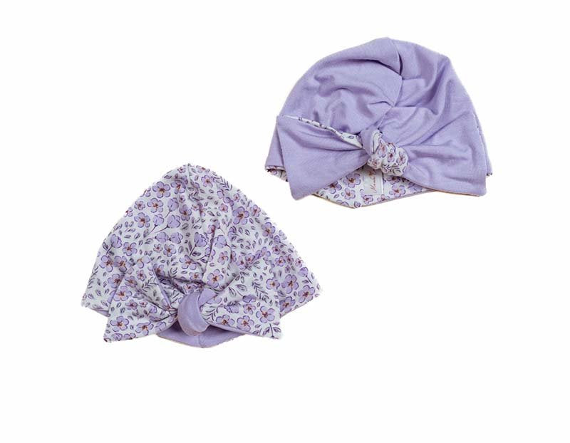 Reversible silky modal ruched baby beanie with bow in bitty blooms design.