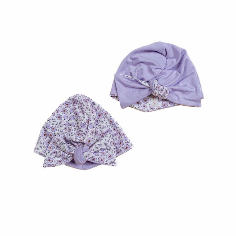 Reversible silky modal ruched baby beanie with bow in bitty blooms design.