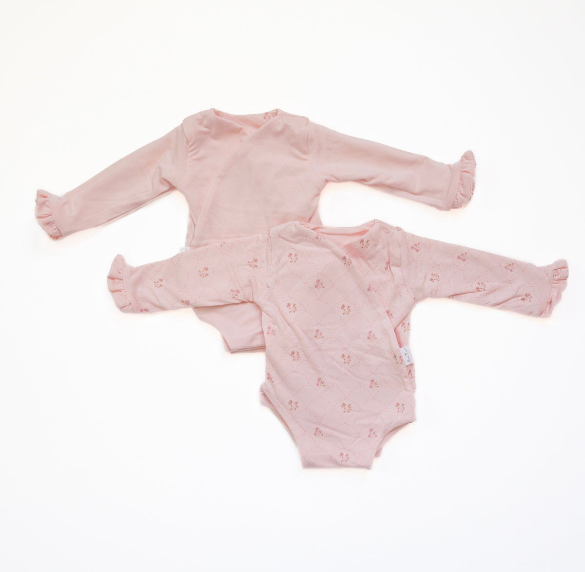 Reversible long-sleeve baby ruffle cuff onesie in dainty dots design.