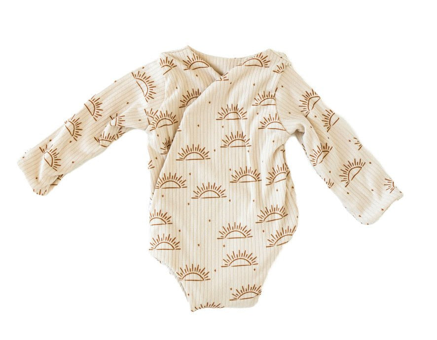 Reversible sandy sunsets design long-sleeve baby onesie in classic brushed fabric.