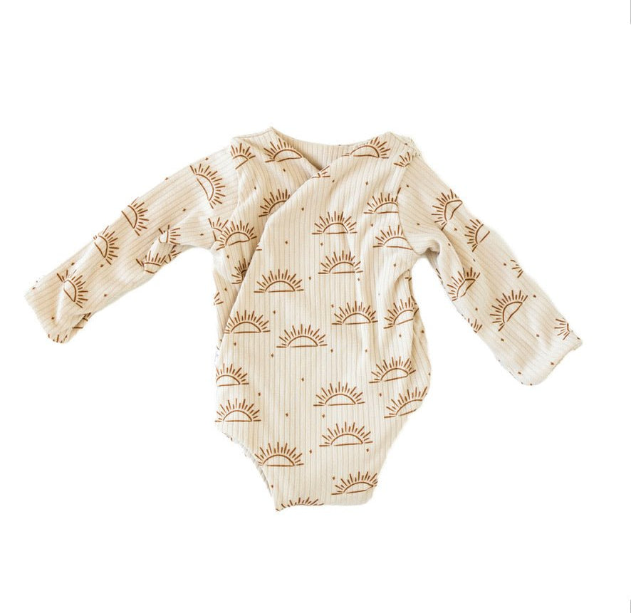 Reversible sandy sunsets design long-sleeve baby onesie in classic brushed fabric.