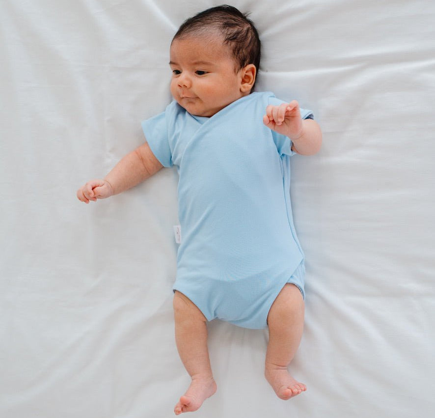 Soft classic brushed reversible short-sleeve winged bodysuit in the Blue Swells design for comfortable everyday wear.