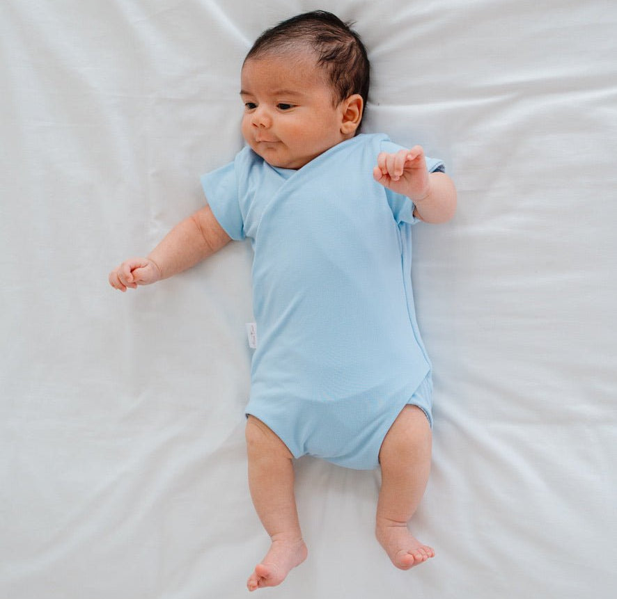 Soft classic brushed reversible short-sleeve winged bodysuit in the Blue Swells design for comfortable everyday wear.