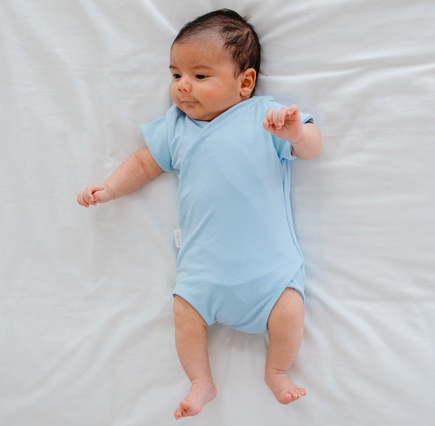 Soft classic brushed reversible short-sleeve winged bodysuit in the Blue Swells design for comfortable everyday wear.