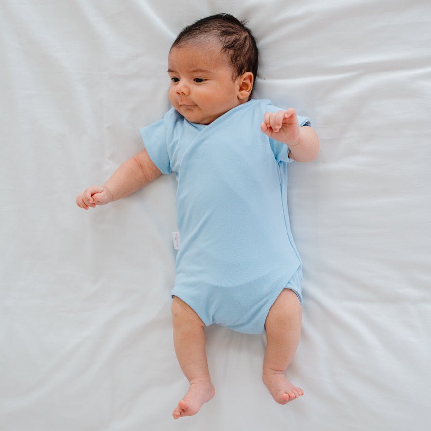 Soft classic brushed reversible short-sleeve winged bodysuit in the Blue Swells design for comfortable everyday wear.