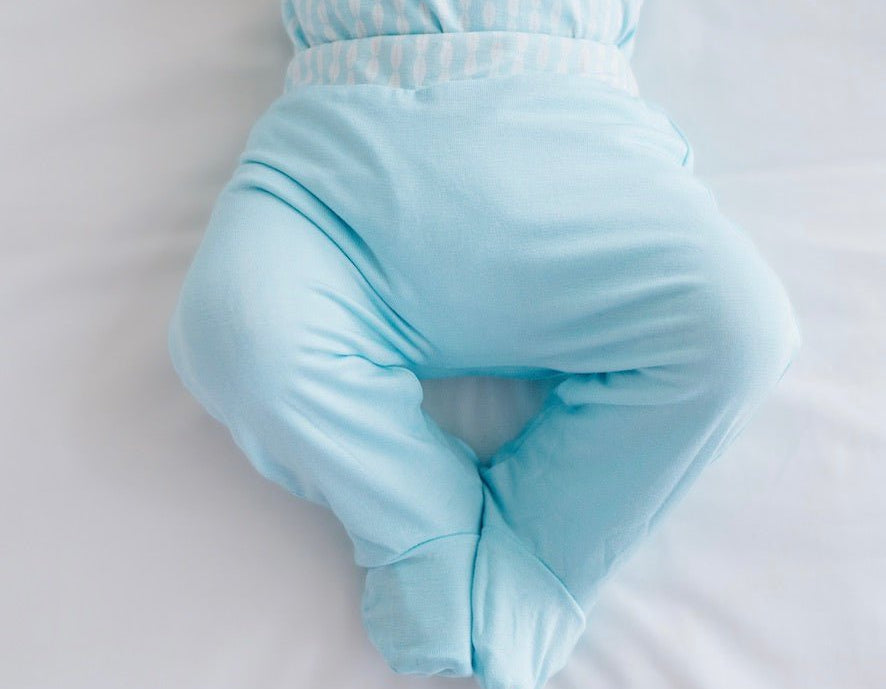 Soft and gentle reversible baby footie pants made from silky modal fabric in the Lil Surfer design.