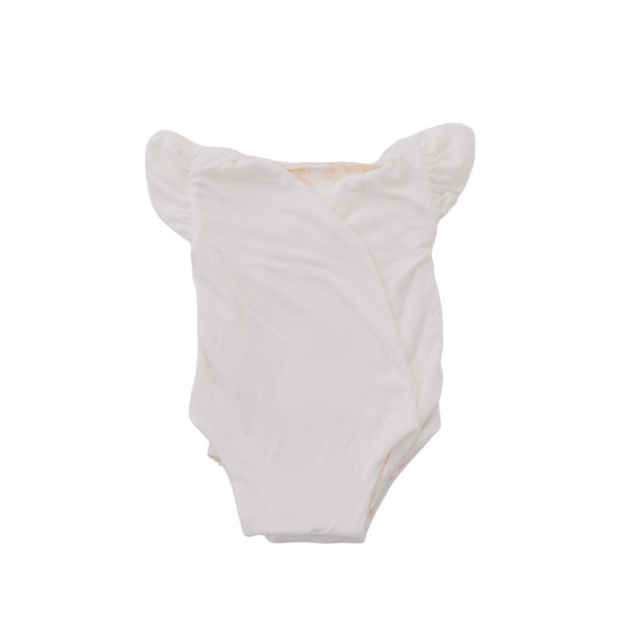 Reversible Bitty Blooms design flutter sleeve winged bodysuit for babies in silky modal fabric.