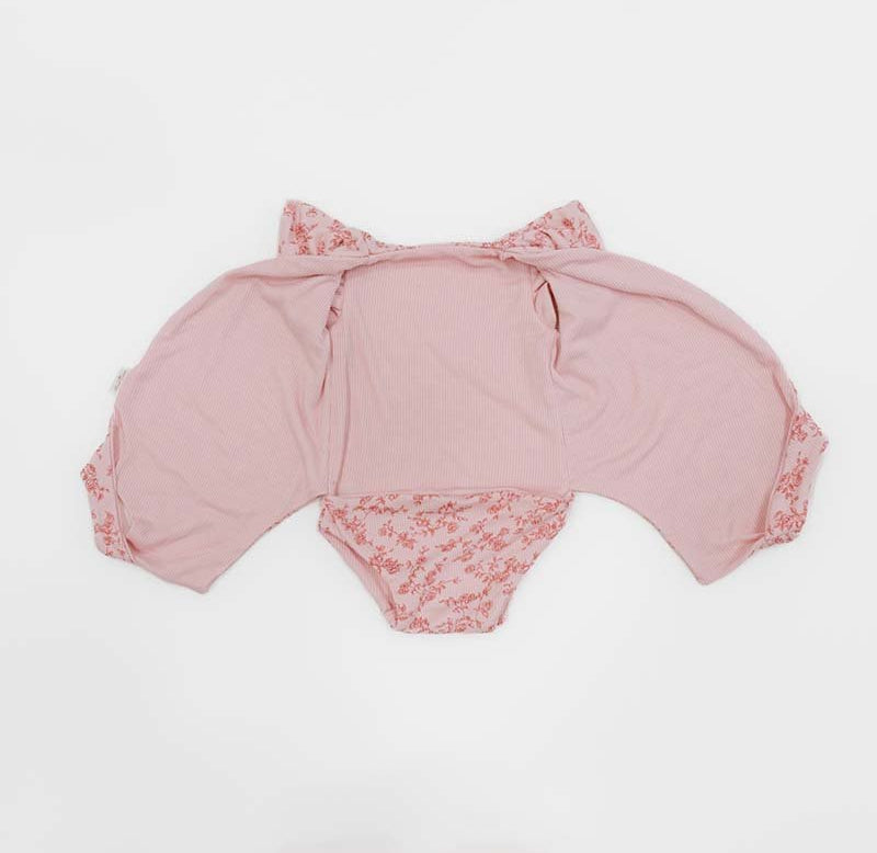 Reversible Bitty Pink Blooms design flutter sleeve winged bodysuit in silky modal fabric.
