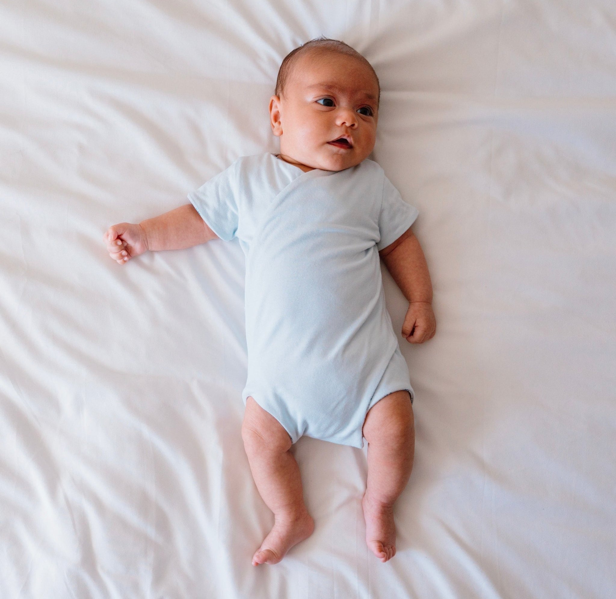 Reversible short-sleeve baby onesie in teddy tiles design.