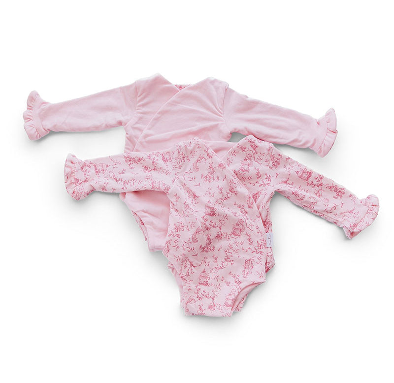 Reversible ruffle cuff long sleeve baby onesie made from bamboo cotton.